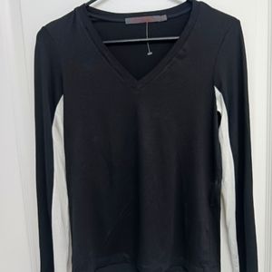 Feel The Piece long sleeve v neck top. Black with black and white sleeves. XS/S